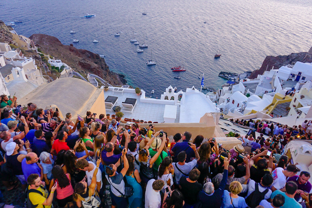 Santorini sunset crowd tourists daisy rae travel
